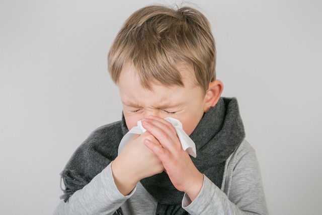 boy sneezing
