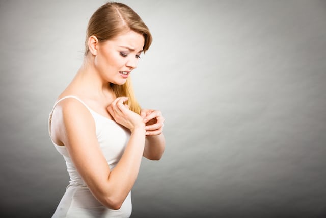 woman scratching roach allergy