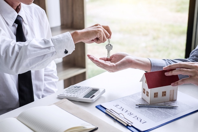 estate agent handing keys to london property
